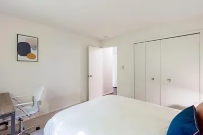 a bedroom with a bed and a desk and a chair at Midtown 3402I Cozy & Comfy I Free Parking in Parma