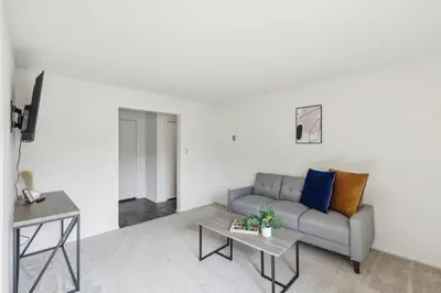 a living room with a couch and a table at Midtown 3402I Cozy & Comfy I Free Parking in Parma