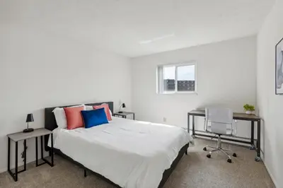a bedroom with a bed and a desk and a chair at Midtown 3602I Cozy & Comfy I Free Parking in Parma