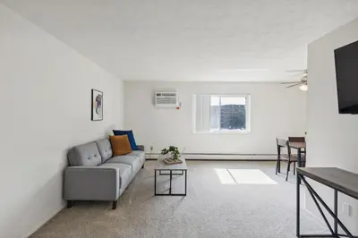a living room with a couch and a table at Midtown 3602I Cozy & Comfy I Free Parking in Parma