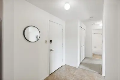 a hallway with white walls and a mirror at Midtown 3602I Cozy & Comfy I Free Parking in Parma