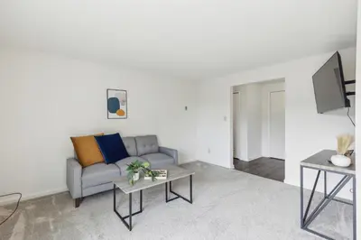 a living room with a couch and a tv at Midtown 3603 I Cozy & Comfy I Free Parking in Parma