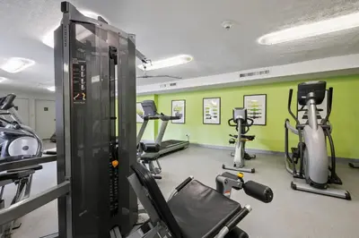 a gym with several tread machines in a room at Midtown 3605I Cozy & Comfy I Free Parking in Parma