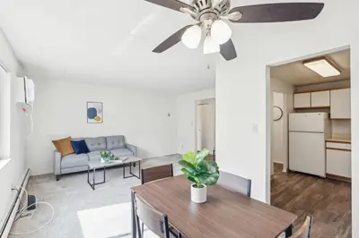 a living room with a table and a ceiling fan at Midtown 3605I Cozy & Comfy I Free Parking in Parma