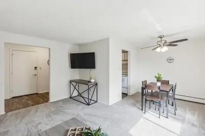 a living room with a table and a ceiling fan at Midtown 3605I Cozy & Comfy I Free Parking in Parma