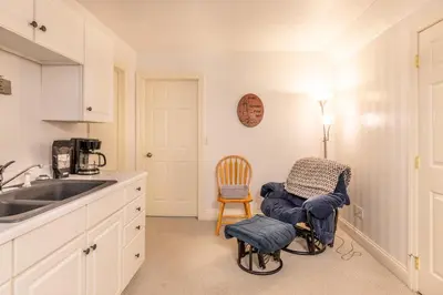 a kitchen with a sink and a chair at Owl's Nest Retreat in Russellville