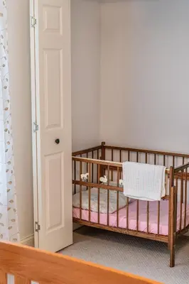 a bedroom with two bunk beds and a door at Owl's Nest Retreat in Russellville
