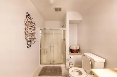 a bathroom with a shower stall and a toilet at Owl's Nest Retreat in Russellville