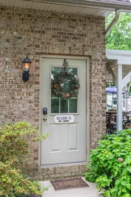 a white door with a christmas wreath on it at Owl's Nest Retreat in Russellville