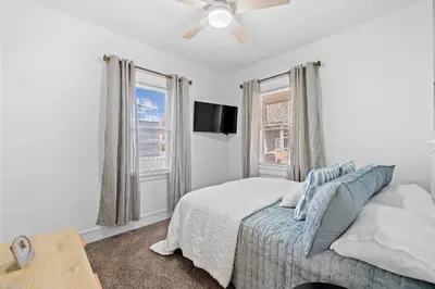 a bedroom with a bed and a flat screen tv at Comfortable 2-Bedroom House In Cleveland 1330 in Cleveland