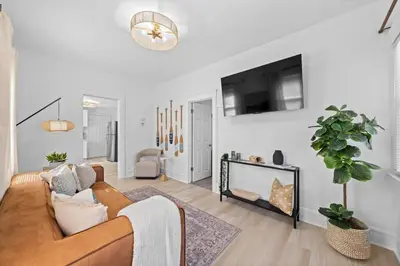 a living room with a couch and a flat screen tv at Comfortable 2-Bedroom House In Cleveland 1330 in Cleveland