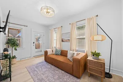 a living room with a couch and some windows at Comfortable 2-Bedroom House In Cleveland 1330 in Cleveland
