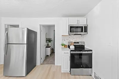 a kitchen with a stainless steel refrigerator and microwave at Comfortable 2-Bedroom House In Cleveland 1330 in Cleveland