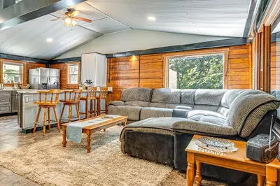 a living room with a couch and a kitchen at Lake Escape with Hot Tub and Docks in Hope! in Hope