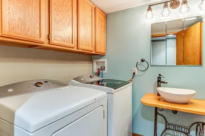 a laundry room with a washing machine and a sink at Lake Escape with Hot Tub and Docks in Hope! in Hope