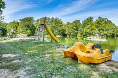 a playground with a slide in the water at Lake Escape with Hot Tub and Docks in Hope! in Hope