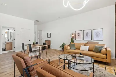 a living room with a couch and a table at Top-Rated 1BR Near Convention Center & Parking in Covington