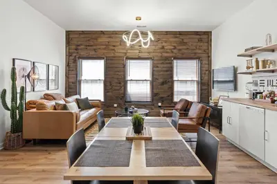 a living room with a table and a couch at Top-Rated 1BR Near Convention Center & Parking in Covington