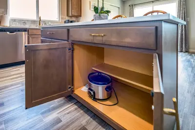 a kitchen with wooden cabinets and a trash can at Full Home by Ark and Creation Museum in Walton