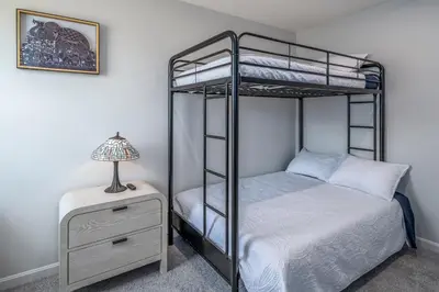 a bedroom with two bunk beds and a nightstand with a lamp at Full Home by Ark and Creation Museum in Walton
