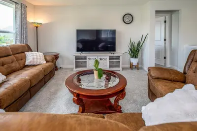 a living room with couches and a tv at Full Home by Ark and Creation Museum in Walton
