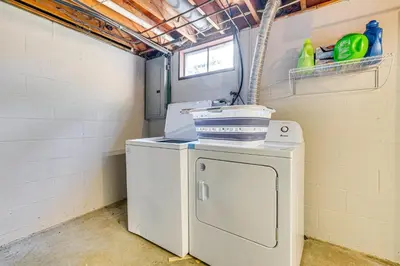 a washer and dryer in a room with a window at 11 Mi to Dtwn Columbus Group Retreat with Fire Pit! in Worthington