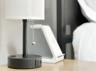 a small lamp sitting on a table next to a phone at Boho Studio Loft Meets Luxury in OTR Cincinnati! in Cincinnati