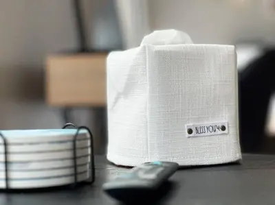 a white speaker sitting on a table next to a remote control at Boho Studio Loft Meets Luxury in OTR Cincinnati! in Cincinnati