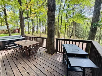 a wooden deck with a picnic table and a bench at Game RoomHot Tub4mi to Rock HouseGives Back! in Laurelville