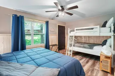a bedroom with two bunk beds and a ceiling fan at Game RoomHot Tub4mi to Rock HouseGives Back! in Laurelville