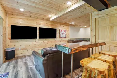a living room with a couch and a television at Game RoomHot Tub4mi to Rock HouseGives Back! in Laurelville