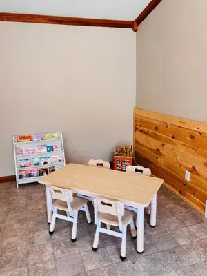 a table and two chairs in a room at Game Room6mi to parksGroup GetawayGives Back! in Logan