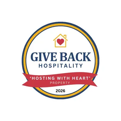 a sign that says give backhospitality hugging with her heart at Game Room6mi to parksGroup GetawayGives Back! in Logan