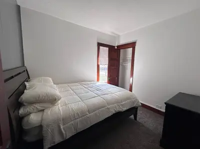 a white bedroom with a bed and a window at 2Bed Apt Near University Hospital in East Cleveland