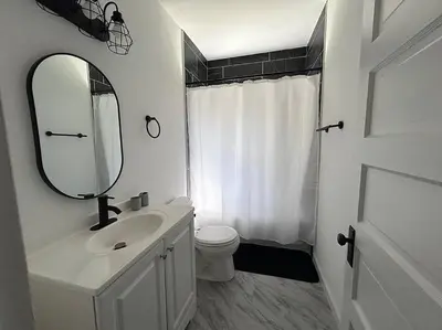 a bathroom with a sink and a toilet and a mirror at 2Bed Apt Near University Hospital in East Cleveland