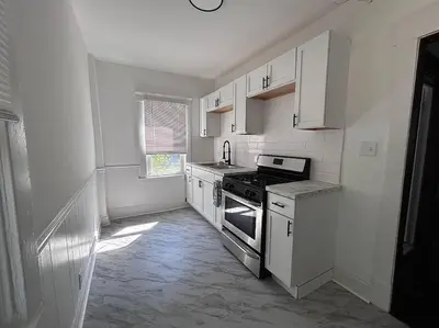 a kitchen with white cabinets and a stove at 2Bed Apt Near University Hospital in East Cleveland