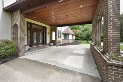 a porch of a house with a wooden ceiling at 12,700 sf 8 Room Mansion on 18 acres in Medina
