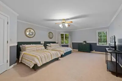 a bedroom with two beds and a ceiling fan at 12,700 sf 8 Room Mansion on 18 acres in Medina