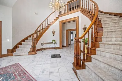 a staircase in a home with a wooden stair case at 12,700 sf 8 Room Mansion on 18 acres in Medina