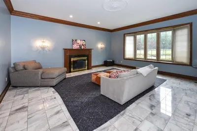 a living room with a couch and a fireplace at 12,700 sf 8 Room Mansion on 18 acres in Medina