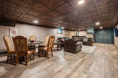 a living room with a couch and a table and chairs at 12,700 sf 8 Room Mansion on 18 acres in Medina