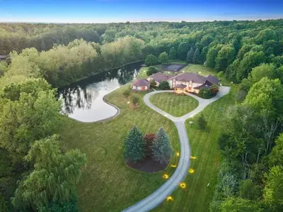 an aerial view of a house with a road at 12,700 sf 8 Room Mansion on 18 acres in Medina