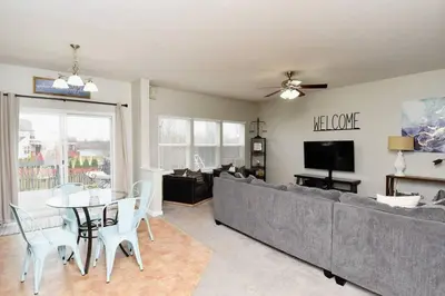 a living room with a couch and a table and chairs at Modern Retreat near downtown Dayton in Dayton