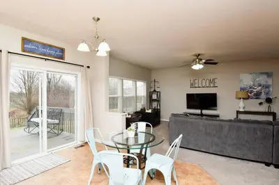 a living room with a glass table and a couch at Modern Retreat near downtown Dayton in Dayton