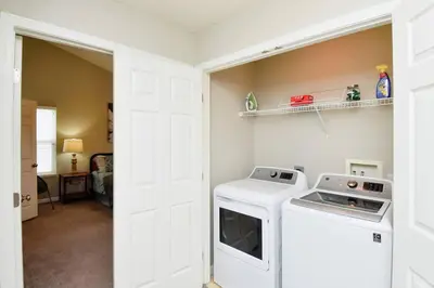 a laundry room with a washer and dryer in it at Modern Retreat near downtown Dayton in Dayton