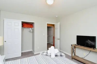 a living room with a flat screen tv on a wall at Modern Retreat near downtown Dayton in Dayton