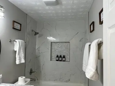 a bathroom with a shower with a tub and a sink at Modern Retreat - Newly Remodeled Gem in Englewood