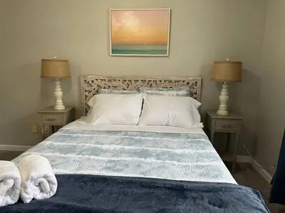 a bedroom with a bed with towels on it at Modern Retreat - Newly Remodeled Gem in Englewood