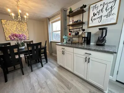 a kitchen with a counter and a table with chairs at Modern Retreat - Newly Remodeled Gem in Englewood