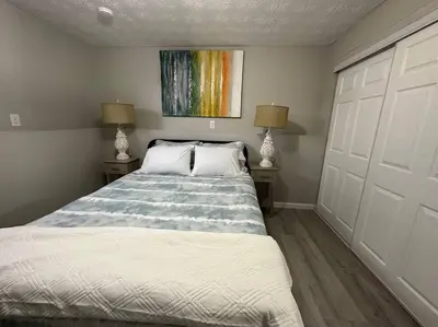 a bedroom with a bed and a painting on the wall at Modern Retreat - Newly Remodeled Gem in Englewood